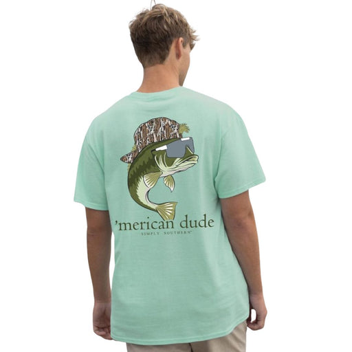 Model wearing light green Simply Southern Bass Chinchilla T-shirt featuring a large fish on the back wearing a trucker cap and sunglasses