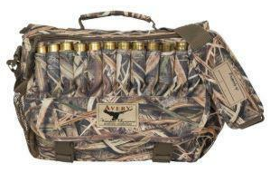 Travel hunting blind bag with shoulder strap and handle on top, and ammunition on the side.