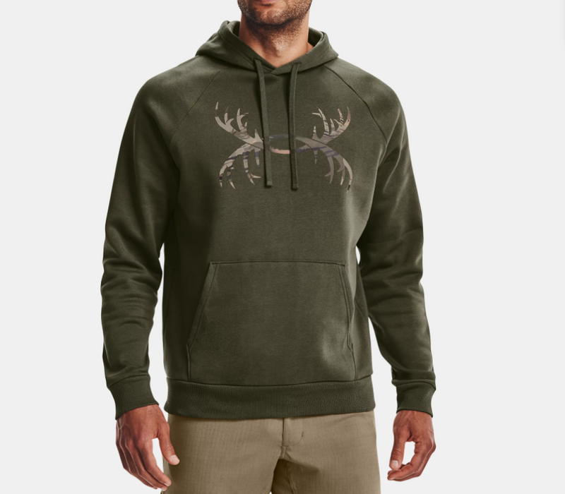 model wearing green draw string hoodie with Under Armour logo is antlers and tan bottoms