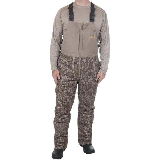 model wearing tan long sleeve and camo bibs and black boots