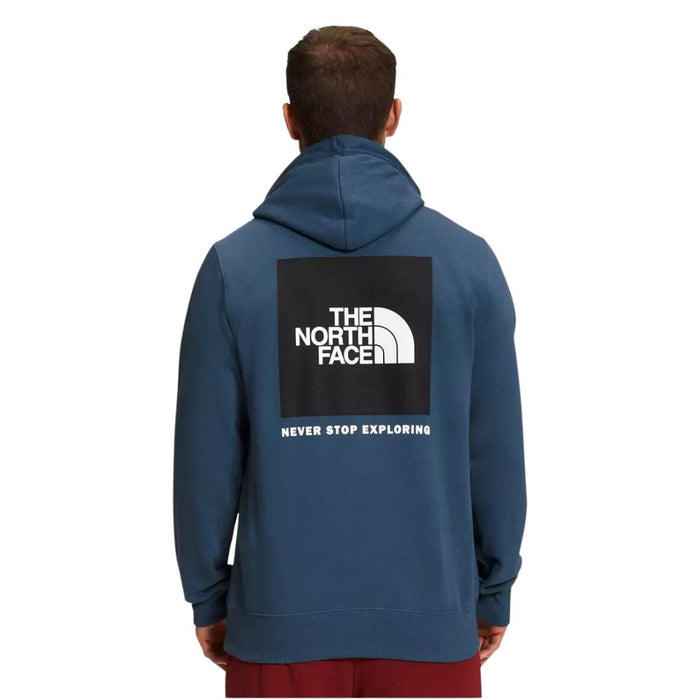 North Face Men's Box Nose Hoodie in navy worn by model with red bottom 